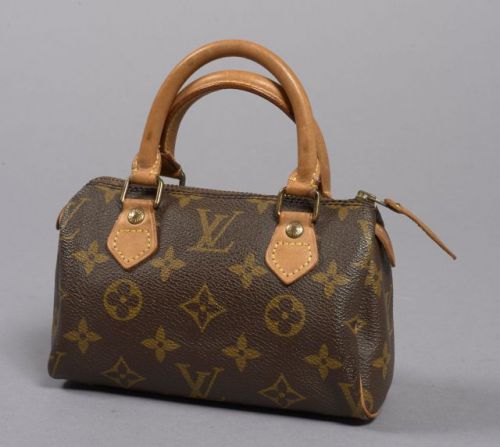 Louis VUITTON, Mini Speedy en toile monogram et cuir naturel. Dimensions: 11 x 16 cm. Petite patine d'usage sinon bon état.