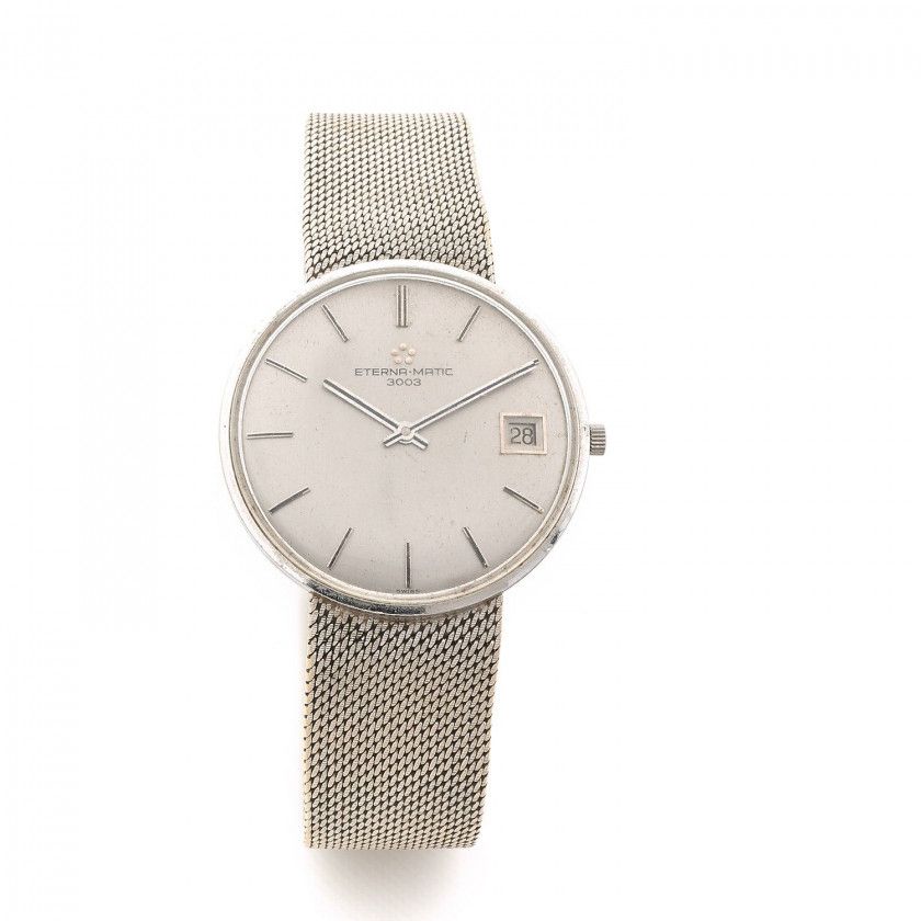 ETERNA-MATIC,3003, n° 844N,Vers 1960,Montre bracelet en or blanc 18k (750),Boîtier: rond, fond clippé, signé,Cadran: argenté, index bâton appliqués, date à guichet, signé,Mouvement: automatique, signé,Bracelet: intégré en or, fermoir siglé,Tour de poignet