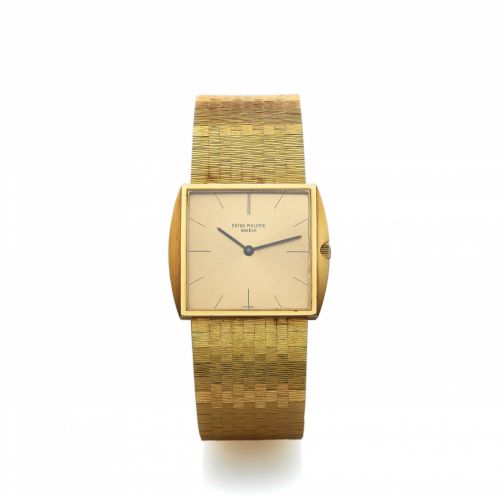 PATEK PHILIPPE REF. 3503 YELLOW GOLD. Patek Philippe, Genève, No. 1135263, case No. 2650798, Ref.. 3503/5. Made circa 1965.. Fine and rare, cushion-shaped, thin, 18K yellow gold. wristwatch with an integral textured 18K yellow gold. Patek Philippe brick b