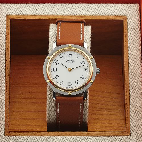 HERMES CLIPPER WRISTWATCH. STEEL AND GOLD. Hermès, Paris. Made circa 1990s. No. 498691.. Fine, steel and gold wristwatch with date.