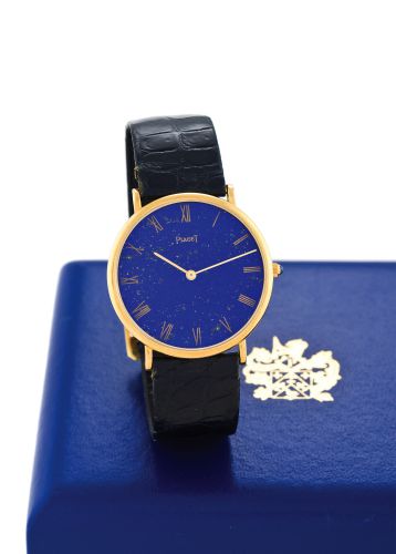 PIAGET, REF. 9035, YELLOW GOLD - LAPIS DIAL - ORIGINAL.CERTIFICATE.Piaget, movement No. 7294034, case No. 260813, Ref. 9035. Sold on April 8th, 1975..Very fine, 18K yellow gold and lapis-lazuli wristwatch with an 18k yellow gold Piaget.deployant clasp. Ac