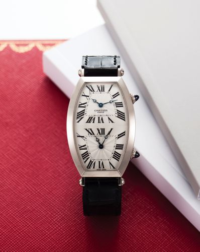CARTIER REF. 2806H TWO TIMEZONE WHITE GOLD.Cartier, Paris, No. 118, Ref. 2806H. Made in the 1990s..Very fine and rare, large, tonneau-shaped, curved, water-.resistant, two time zone, manual winding, 18K white gold.wristwatch with two independent mechanica