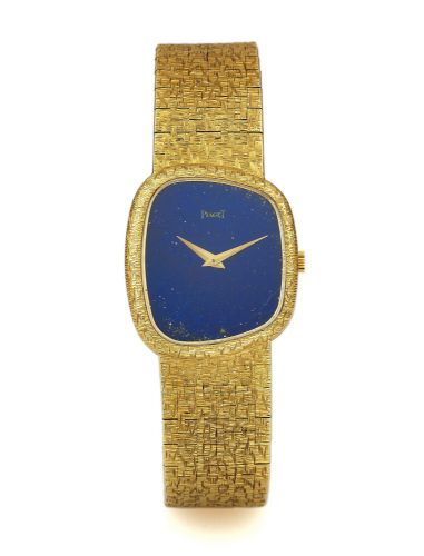 PIAGET REF. 9467 LAPIS DIAL YELLOW GOLD.Piaget, case No. 219520, Ref. 9467-A68. Made in the 1970s..Fine and unusual, asymmetric, 18K yellow gold wristwatch with an integral 18K yellow gold Piaget bark-finished link.bracelet.