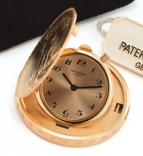 PATEK PHILIPPE REF. 802 TWENTY DOLLAR COIN WATCH YELLOW GOLD.Patek, Philippe, Genève, No. 866647, case No. 2700445, Ref. 802. Made in 1963, sold on.November 27th, 1972..Very fine and rare, thin 18K yellow gold, keyless coin watch set into a 20 U.S. Dollar