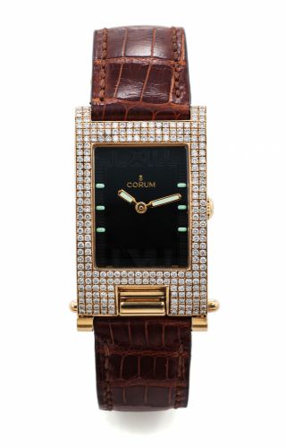 CORUM REF. 64.151.56 TABOGAN.DIAMOND AND YELLOW GOLD.Corum, Tabogan, case No. 594161, Ref. 64.151.56. Made circa 1990s..Fine and unusual, asymmetric, rectangular curved, diamond and.18K yellow gold quartz wrist-watch bearing a sliding and hinged.mechanism