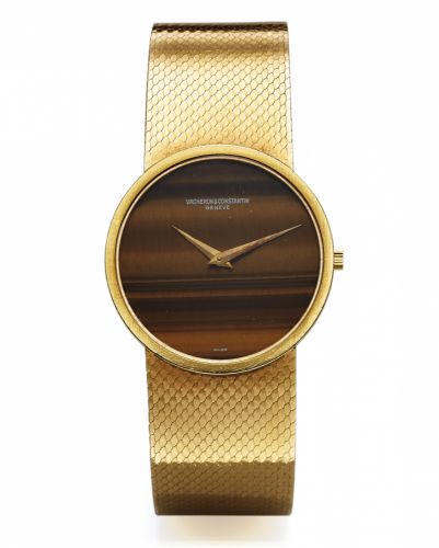 VACHERON CONSTANTIN REF. 7243.TIGER-EYE YELLOW GOLD.Vacheron & Constantin, Genève, movement No. 646957, case.No. 488064, Ref. 7243. Made in the 1970s..Fine and unusual, thin, 18K yellow gold wristwatch with.tiger-eye dial and an integral 18k yellow gold V