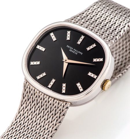 PATEK PHILIPPE REF 3619 TWO TIME ZONE.DIAMOND INDEXES WHITE GOLD.Patek Philippe, Genève, Two Time Zone, No. 739768, case No. 2757187, Ref. 3619/1. Made circa 1980..Very fine and rare, large, horizontal oval, 18K white gold wristwatch with two time zones a