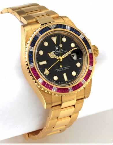 ROLEX REF. 116748 GMT YELLOW GOLD.DIAMONDS RUBIES & SAPPHIRES.Rolex, Oyster Perpetual Date GMT Master II.Superlative Chronometer Officially Certified.Ref. 116748 SARU. Made in 2006..Very fine, two time zone, center seconds, self-winding.18K yellow gold wr