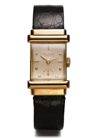 PATEK PHILIPPE REF. 2480 YELLOW GOLD.Patek Philippe, Genève No. 976528 case No. 673899, Ref. 2480..Made in the early 1950s..Very fine and very rare rectangular bombé18K yellow gold.wristwatch with an 18K yellow gold Patek Philippe buckle.