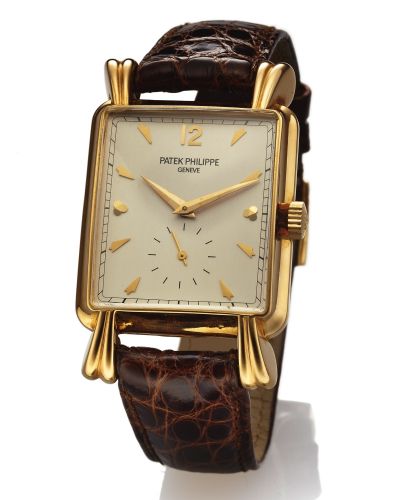 PATEK PHILIPPE REF. 2440.FLUTED TEARDROP LUGS YELLOW GOLD.Patek Philippe, Genève, No. 956022, case No. 663016.Ref. 2440. Made in 1951..Very fine and very rare, rectangular, 18K yellow gold.wristwatch with an 18K yellow gold Patek Philippe buckle.