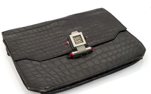 VERGER ART DECO SHUTTER WATCH Fine and unusual, 18K white gold, black lacquered and malachite-set Art-Deco handbag buckle incorporating a built-in watch with shuttered concealed dial with an Hermes crocodile leather bag.