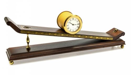 IMHOF INCLINED CLOCK BRASS AND WOOD A fine self-winding brass inclined clock. Accompanied with original box and certificate