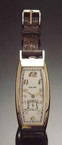 Movado, Polyplan, Swiss, No. 401710.1920's..Fine 14 ct. gold, tonneau shaped curved.gentleman's wristwatch.