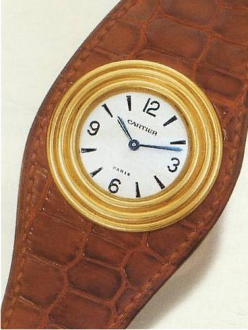 Cartier, Paris, No. A 105807, Ref. 1809. Produced in the 1980's..Very fine and rare circular stepped 18K yellow gold gentleman's wristwatch integrated in a leather bracelet.