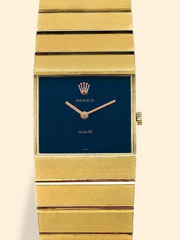 Rolex Queen Midas, No. 2568, Ref. 3585. Produced in the 1960's.Very fine, rectangular, 18K yellow gold mid-size wristwatch with an 18K yellow gold integral bracelet and deployant clasp.