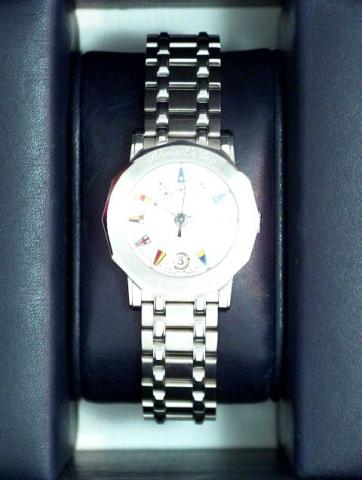 Corum Admiral's Cup, Ref. 39.130.20 V 585. Produced in the 1990's, sold on January 15, 2003..Very fine, dodecagonal, center-seconds, water-resistant, stainless steel lady's quartz wristwatch with date and an 18K brushed stainless steel Corum bracelet deco