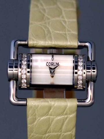 Corum, Ref. 130.330.47. Produced in the late 1990's, sold on January 15, 2003..Very fine and unusual, semi-cylindrical, stainless steel and diamond driver's quartz wristwatch with two extended tubular mobile lugs forming a horizontal rectangle and a stain