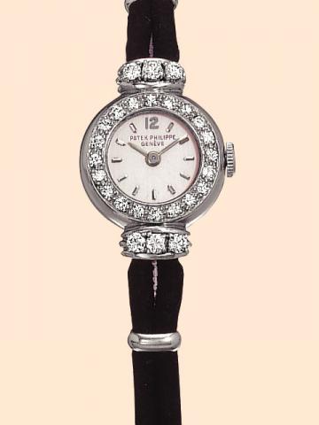 Patek Philippe & Cie, Geneve, No. 945327, case No. 513493, Ref. 3152. Produced circa 1951. Very fine, platinum and diamond lady's wristwatch with cord bracelet, platinum rings and clasp.