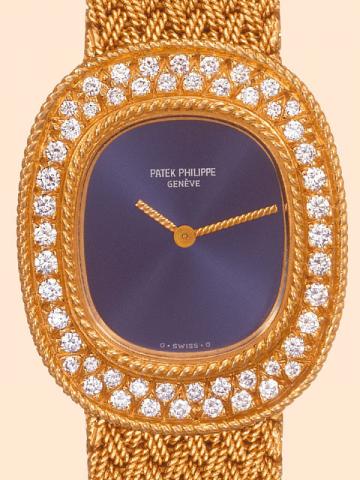Patek Philippe & Cie, Geneve, No. 1391012, case No. 2763710, Ref. 4396/1. Produced in the 1980 's. Very fine, oval, 18K yellow gold and diamonds lady's wristwatch with an 18K yellow gold woven Patek Philippe bracelet 