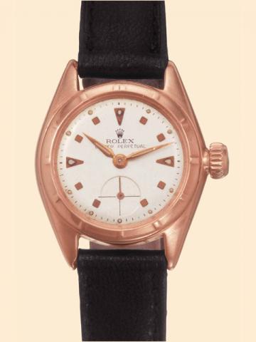 Rolex Oyster Per-petual, Ref. 5003. Made in the 1950s. Fine, tonneau-shaped, self-winding, water-resistant, 18K pink gold lady's wristwatch with a pink gold-plated Rolex buckle.