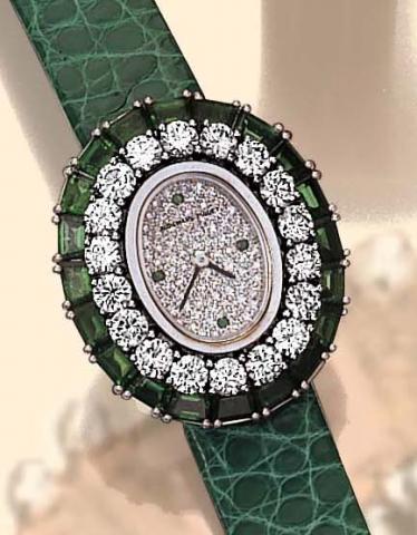 Audemars Piguet, Geneve, No. 1, Ref. 41389. Manufactured in the 1990s. Very fine, oval, 18K white gold, diamond and emerald lady's quartz wristwatch with a green leather strap and an 18K white gold Audemars Piguet buckle.