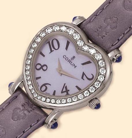 Corum, Ref. 24.183.20. Produced in the 1990s. Fine, heart-shaped, stainless steel, diamonds and cabochon sapphire lady's quartz wristwatch with a satin_ blue leather strap engraved with the logo and a stainless steel Corum buckle.