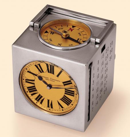 L. Regnier, France, retailed by Gorham Company, New York. Fine and rare, cube-shaped, silver desk timepiece with a clock, calendar, barometer, thermometer in Fahrenheit and Centigrade, and a compass. Accompanied by a fitted box.
