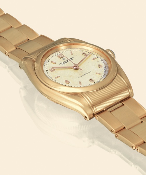 Ref. 6065 Rigid Hooded, Chronometre.Rolex, Oyster Perpetual, Chronometre.Ref. 6065, Rigid Hooded. Made in 1950..Very fine and rare, tonneau-shaped, water-resistant, center.seconds, self-winding, 18K yellow gold gentleman's chronometer.wristwatch with hood