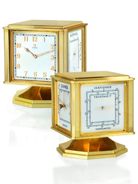 DESK WEATHER STATION.Omega, Bienne, No. 1106697, Ref. 5531. Made in 1950..Very fine and rare, gold-plated bronze, four-dialed, eight-day going, keyless revolving.desk timepiece with hygrometer, barometer and thermometer in Fahrenheit and.Centigrade. Accom