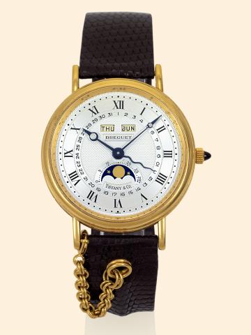 Serpentine.Breguet, Serpentine, No. 207, Ref. 3332.retailed by Tiffany & Co. Made in the 1980s..Very fine, astronomic, self-winding, 18K yellow gold gentleman's.wristwatch with triple date, moon phases, age of the.moon, an 18K yellow gold Breguet buckle a