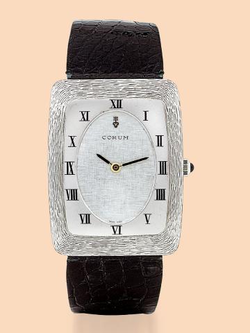 Corum, Ref. 8856-5. Made in the 1980s..Very fine and unusual, rectangular curved.18K white gold wristwatch with a stainless.steel Corum buckle.