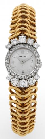 Cartier, Inc., No. 1055051, case No. 662143, Ref. 4772. Made in the 1940s..Fine and rare 18K yellow gold, platinumand diamond lady's wristwatch with backwind and an integral articulated woven.bracelet.