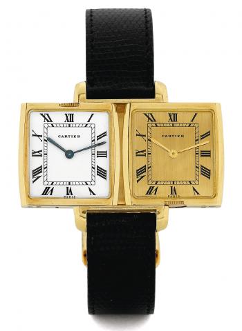 Yellow Gold Dual Time Reverso.Cartier Paris, Reversible with two Movements, No. 034781. Made in the 1970s..Very fine and rare, tonneau-shaped, two time zone, 18K yellow gold reversible wristwatch with two movements and two dials and.an 18K yellow gold Car