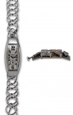 Polyplan.Movado, Chronometer, movement No. 400884, case No. 400956.Ref. G 4002..Fine and very rare, tonneau-shaped, curved, 18K white gold lady's wristwatch with.Polyplan movement and mobile gold-plated silver bracelet with initials N.T. G..on the case an