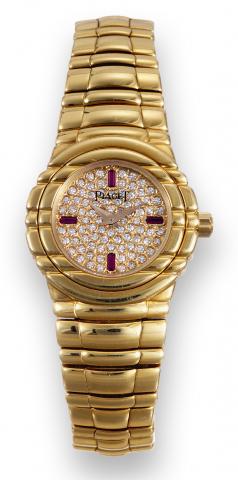 Piaget, Tanagra, No. A.056, case No. 542211, Ref..GOA15264. Made circa.2000..Fine and elegant, 18K yellow gold.diamond and ruby-set lady