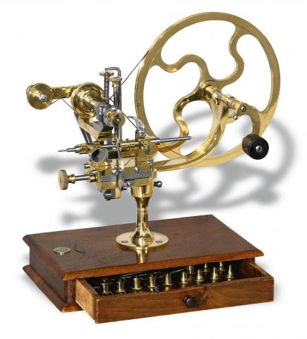 Rounding-Up Tool.Retailed by Sandoz Fils & Co., La Chaux-de- Fonds.Bienne, No. 5367, Swiss. Made in the late 19th century..Fine, brass and steel rounding-up tool on wooden base with.selection of cutting wheels.