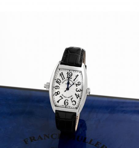 Franck Muller Secret Hours.Franck Muller, Geneve, Master of Complications, Secret.Hours, No. 29, Ref. 7880 SE H I. Made circa 2007..Very fine and unusual, large, curved tonneau-shaped, selfwinding.water-resistant, 18K white gold wristwatch with two.crowns