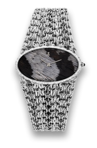 Corum - White Gold - Feather Dial.Corum, movement No. 94058, case No. 120253.Ref. 2712259. Made in 1975..Very fine, exotic, horizontal oval, 18K white gold lady's.wristwatch with bicolor pheasant feather dial and wide.tapering integral 18K white gold twis