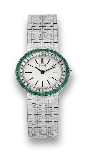 PIAGET DIAMOND AND EMERALD.Piaget, No. 7291611, case No. 121816, Ref. 9314 A 6. Made.in the 1970's..Fine, 18K white gold, diamond and emerald set lady's oval.wristwatch with an integral bark-finished 18K white gold.Piaget bracelet.
