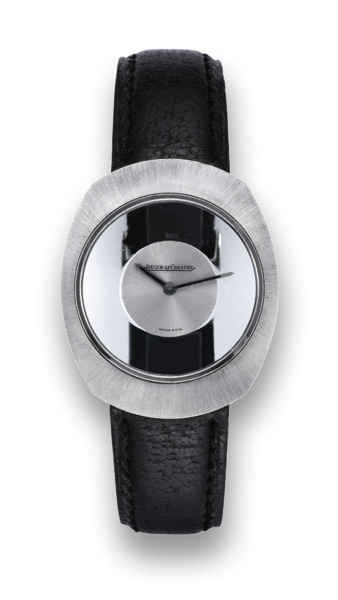 JAEGER LECOULTRE MYSTERY WHITE GOLD.Jaeger-LeCoultre, case No. 1278699, Ref. 17006. Made in.the 1970's..Fine and unusual, mystery type tonneau-shaped 18K white.gold wristwatch with hooded lugs with a stainless steel.Jaeger LeCoultre buckle..To be sold wit