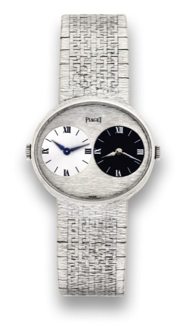 PIAGET REF. 612501.TWO TIME ZONE.Piaget, Two-Time-Zone, Ref. 612501..Made in the 1970s..Fine and unusual, horizontal oval.two-time zone, 18K white gold.wristwatch with two movements, two.dials and an integrated18K white gold.Piaget bracelet.