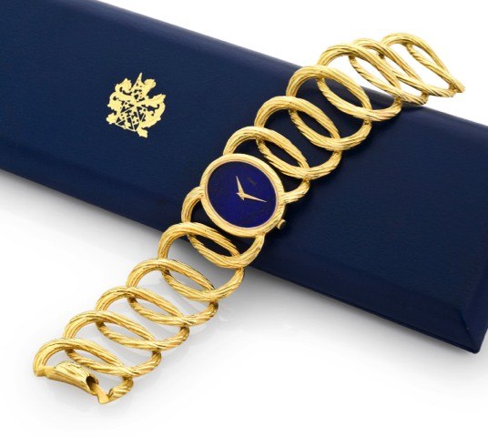 PIAGET, REF. 9852D65 YELLOW GOLD & LAPIS.LAZULI BRACELET WATCH.Piaget, No. 194854, Ref. 9852D65. Made circa 1980..Very fine and elegant, 18K yellow gold lady’s bracelet watch.with lapis lazuli dial and integral 18K yellow gold Piaget.bracelet. Accompanied
