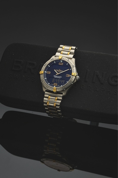 BREITLING REF. F56062.AEROSPACE TITANIUM AND GOLD.Breitling, Genève, Aerospace, No. 01639, Ref. F 56062. Made in the 1990’s..Fine, two time zone, water-resistant, titanium and gold quartz wristwatch with timer, chronograph to 1/100th seconds, a