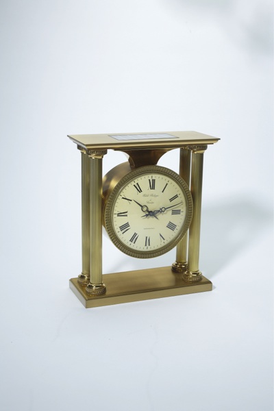 PATEK PHILIPPE REF. 1504 SOLAR EMPIRE STYLE CLOCK RETAILED BY TIFFANY & CO BRASS.Patek Philippe, Genève, No. 873897. Made circa 1965..Fine and rare, gilt brass, solar-powered Empire-style mantel clock with electrically-wound remontoir.