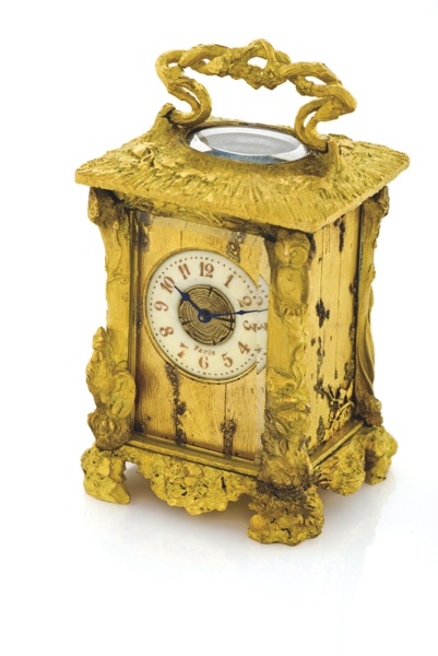 SANDOZ PENDULETTE RUSTIQUE.Gustave Sandoz, Paris, No. 9048. Made circa 1890..Very fine and highly unusual, miniature, gilt-brass naturalistic style, 8-day going carriage clock. Accompanied by the original travelling case (distressed) and key.