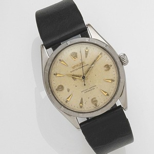 Oyster Perpetual, Ref:6565, Case No.838**, Movement No.521***, Circa 1956 25-jewel Cal.1030 automatic movement adjusted to temperature and 5 positions, champagne hobnail engraved dial with applied gilt faceted arrow hour markers and Arabic quarters, gilt 