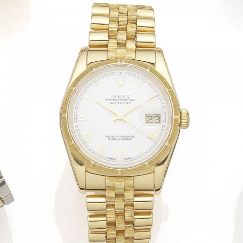 Rolex. An 18K gold automatic calendar bracelet watch