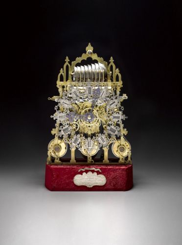 A fine quarter chiming brass skeleton clock with deadbeat escapement and a dome