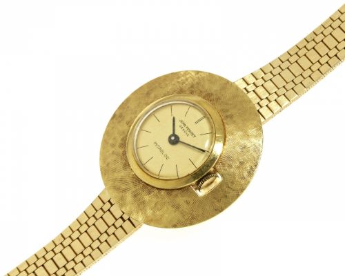 Jean Perret, Geneve. A lady's 18K gold and steel manual wind bracelet watch