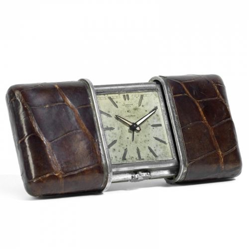 Movado. A steel and leather manual wind alarm sliding travel timepiece